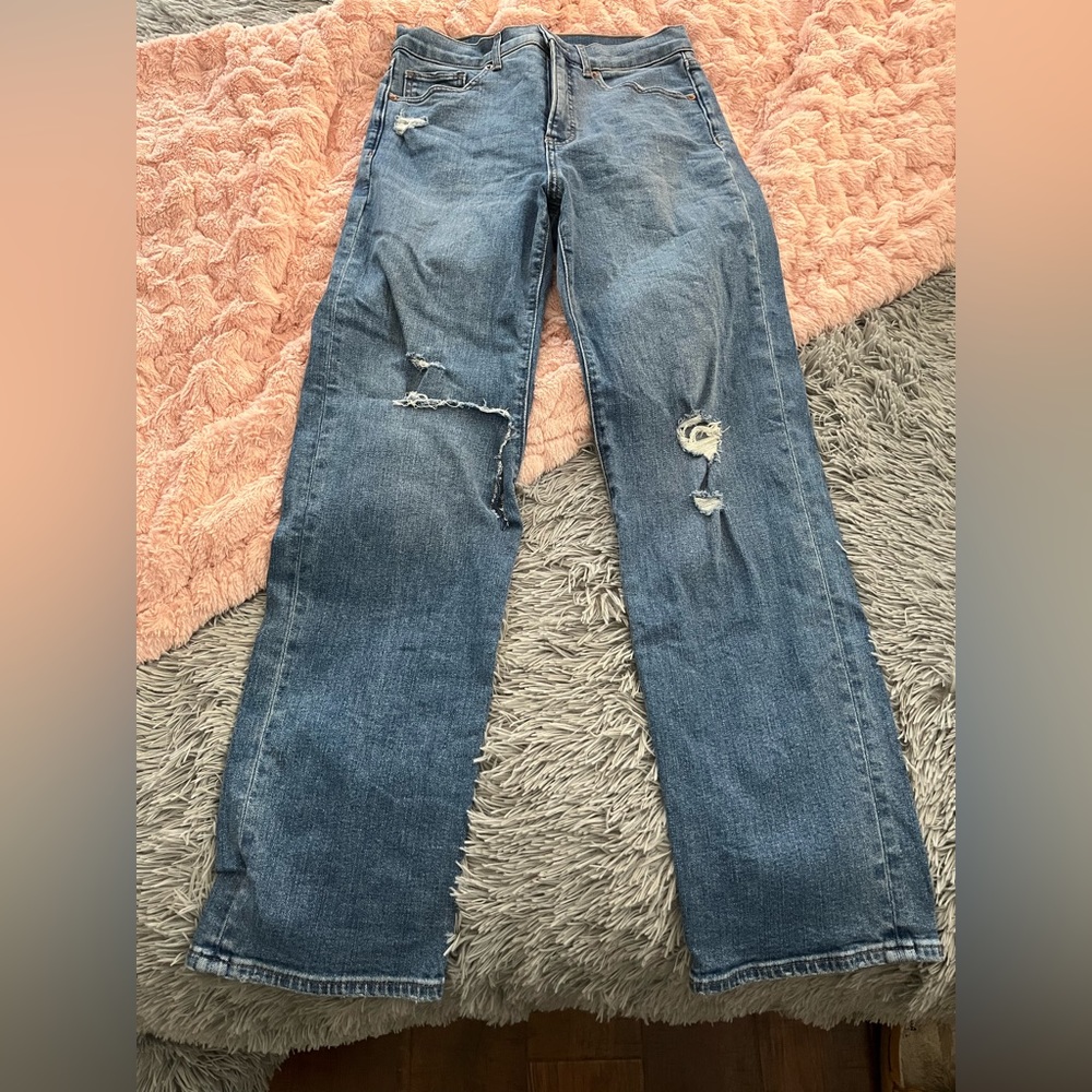 Medium wash straight high waisted jeans with light disstressing.